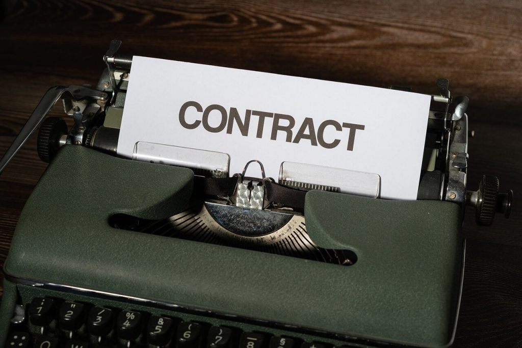 a contract coming out of a typewriter