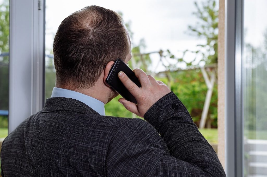 a man talking on a cell phone