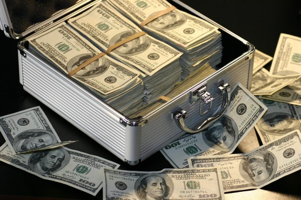 paper money in a silver suitcase